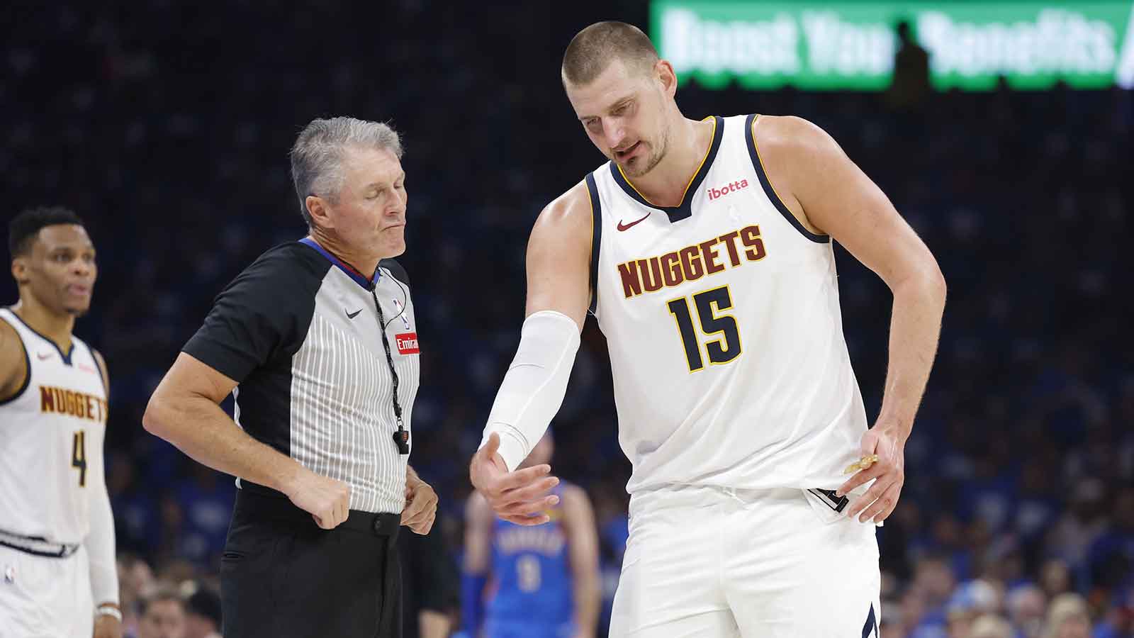 Denver Nuggets center Nikola Jokic (15) talks to an official during a break in play against the Oklahoma City Thunder in the second quarter during game seven of the second round for the 2025 NBA Playoffs at Paycom Center. 