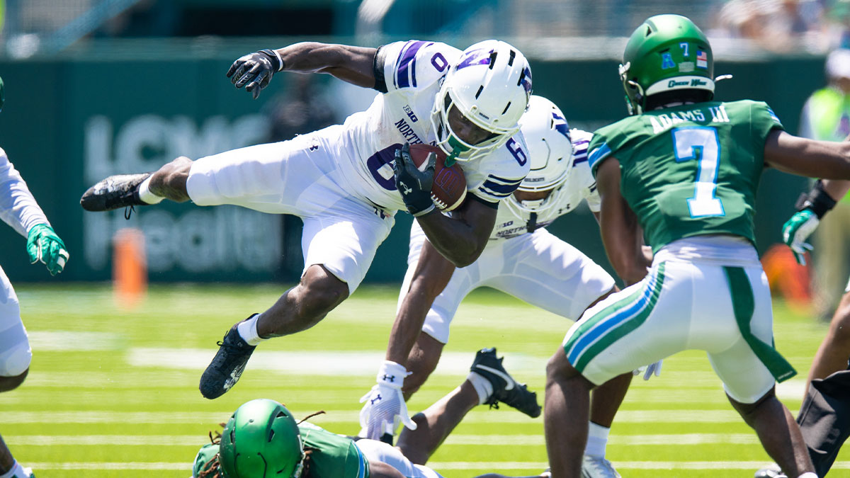 Northwestern Wildcats running back Joseph Himon II (6) is tackled by Tulane Green Wave safety Jack Tchienchou (1) during the second half at Yulman Stadium.