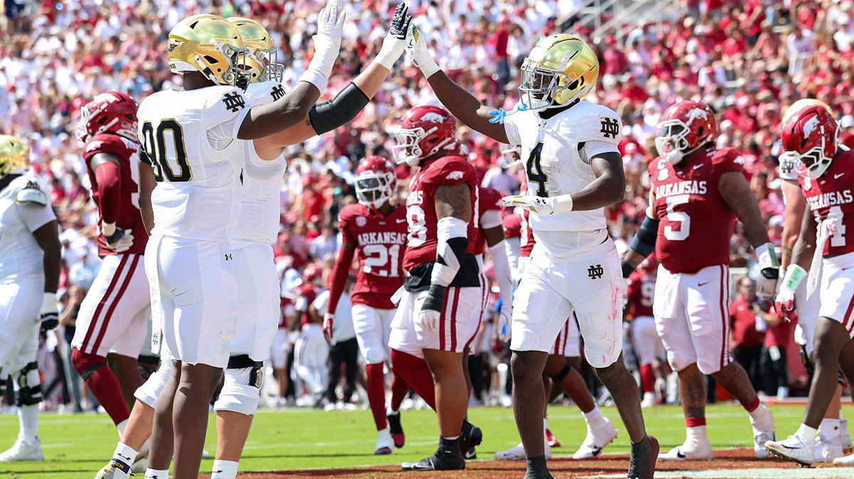 Notre Dame Fighting Irish running back Jeremiyah Love (4) celebrators with teammates after scoring a touchdown in the second quarter against the Arkansas Razorbacks at Donald W. Reynolds Razorback Stadium.