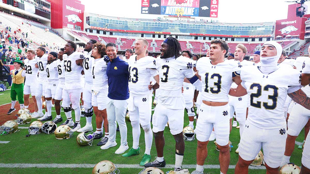 Notre Dame Fighting Irish head coach Marcus Freeman leads the team in celebration after the game against the Arkansas Razorbacks at Donald W. Reynolds Razorback Stadium. Notre Dame won 56-13.