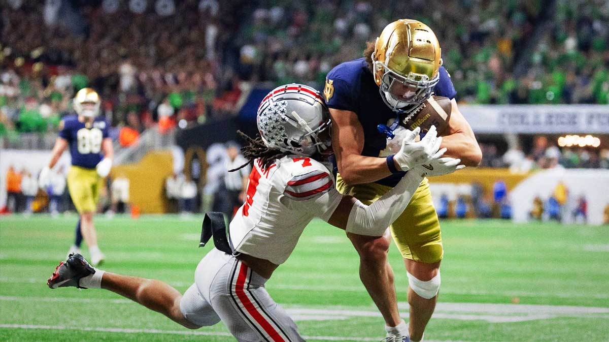 Notre Dame Fighting Irish wide receiver Jaden Greathouse (1) makes a catch for a touchdown against Ohio State Buckeyes cornerback Jordan Hancock (7) during the second half the CFP National Championship college football game at Mercedes-Benz Stadium.