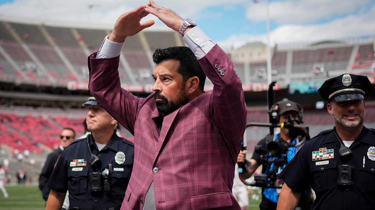 Ohio State Buckeyes head coach Ryan Day gives students an I-O response to their O-H while walking across the field as the team arrives prior to the NCAA football game against the Grambling State Tigers.