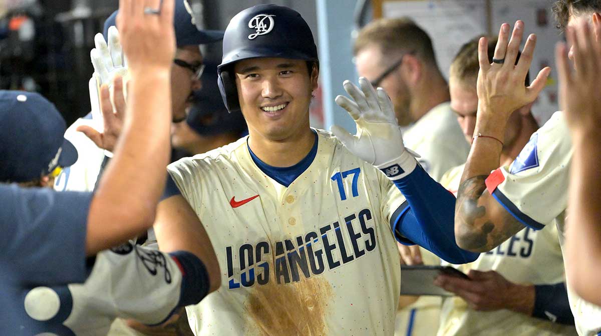 Los Angeles Dodgers designated hitter Shohei Ohtani (17) is congratulated in the dugout after hitting a solo home run in the fifth inning against the San Francisco Giants at Dodger Stadium.