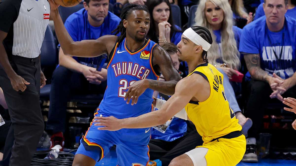 Oklahoma City Thunder guard Cason Wallace (22) looks to pass the ball by Indiana Pacers guard Andrew Nembhard (2) during the third quarter of game two of the 2025 NBA Finals at Paycom Center.