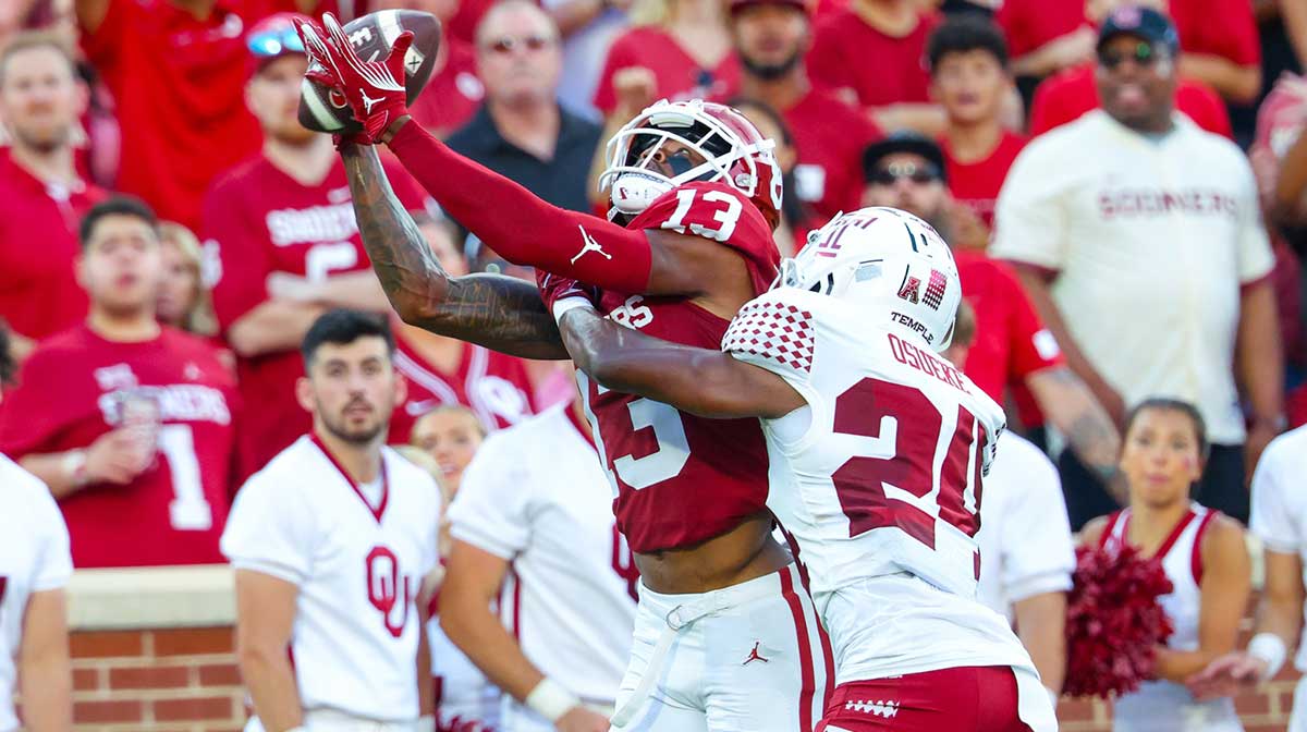 Oklahoma Sooners wide receiver J.J. Hester (13) cannot make a catch as Temple Owls cornerback Ben Osueke (24) defends during the second quarter at Gaylord Family-Oklahoma Memorial Stadium. 