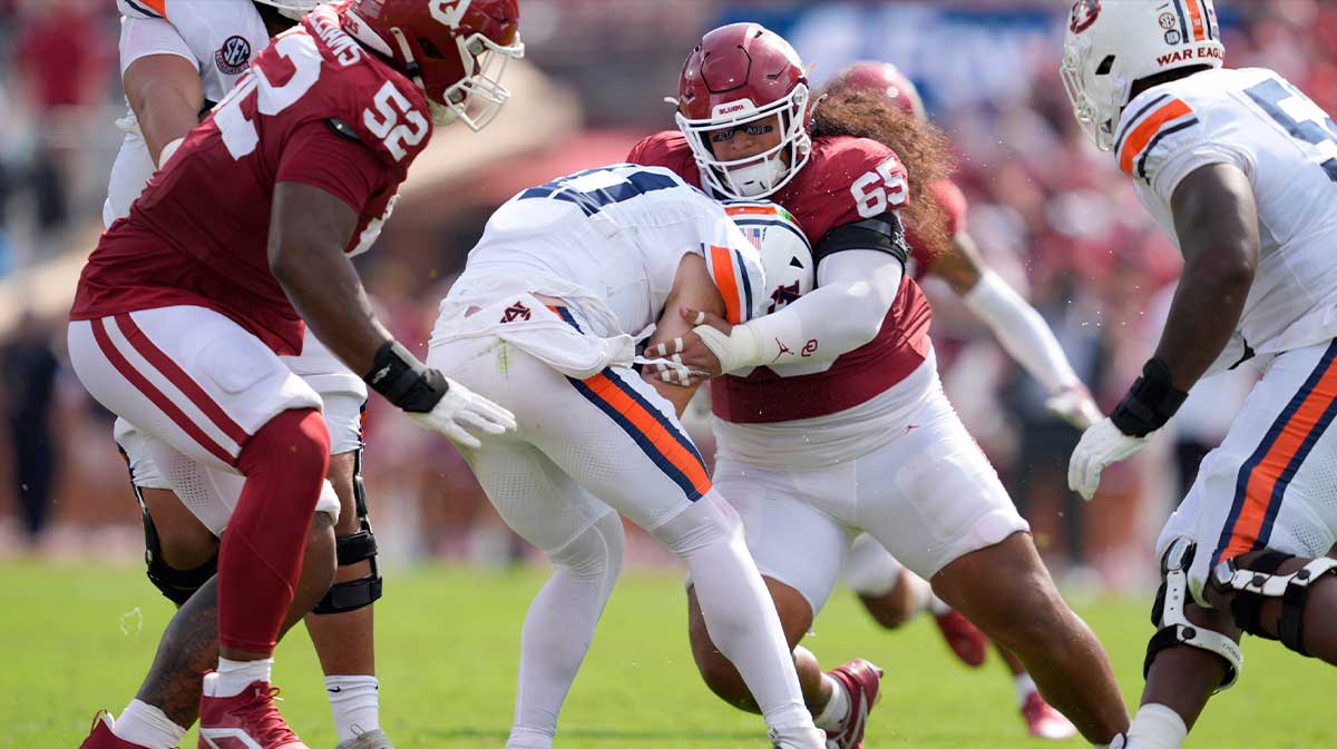 Oklahoma Sooners defensive lineman Jayden Jackson (65) brings down Auburn Tigers quarterback Jackson Arnold (11) during a college football game between the University of Oklahoma Sooners (OU) and the Auburn Tigers at Gaylord Family Ð Oklahoma Memorial Stadium in Norman, Okla., Saturday, Sept. 20, 2025.