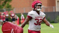 DE R Mason Thomas carries a pad back to the station at the University of Oklahoma (OU) first fall open football practice