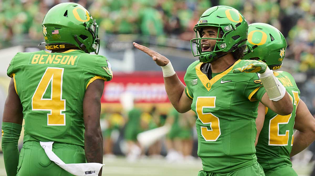 Oregon Ducks quarterback Dante Moore (5) celebrates with wide receiver Malik Benson (4) after Oregon scored a touchdown during the first half against the Oklahoma State Cowboys at Autzen Stadium.
