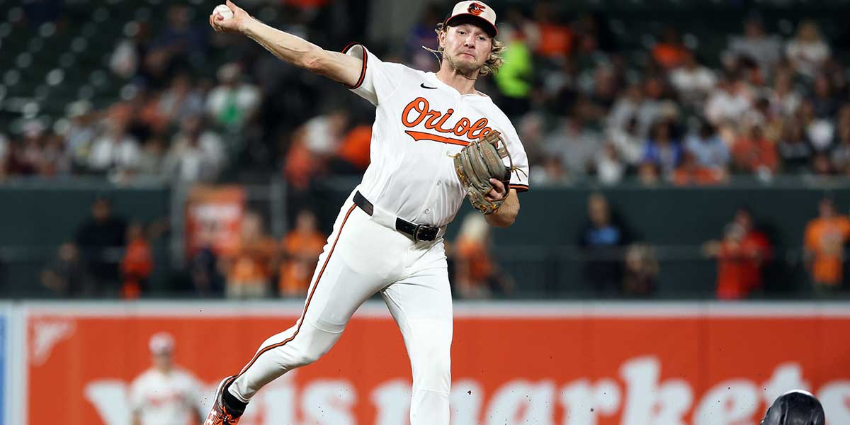 Baltimore Orioles shortstop Gunnar Henderson (2) turns a double play past New York Yankees outfielder Aaron Judge (99) during the third inning at Oriole Park at Camden Yards.
