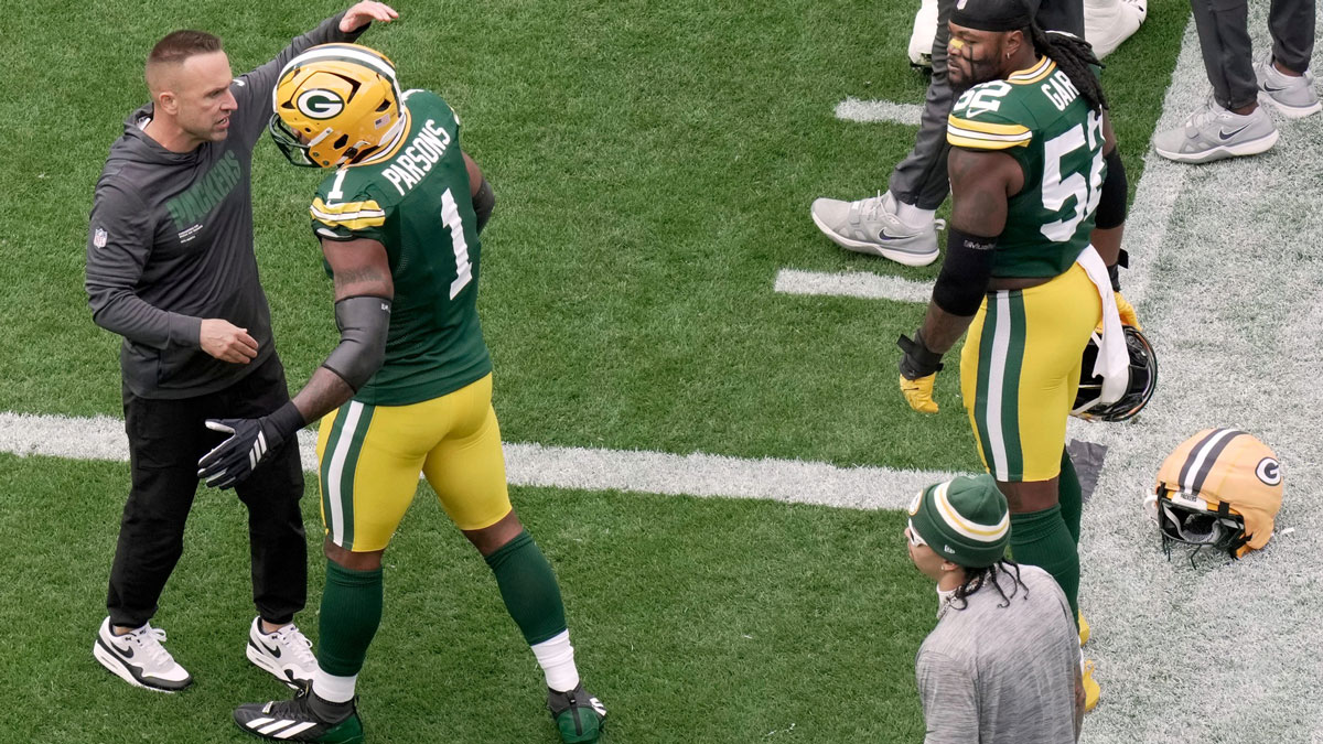 Green Bay Packers defensive coordinator Jeff Hafley hugs defensive end Micah Parsons (1) as defensive end Rashan Gary (52) looks on before their game against the Detroit Lions Sunday, September 7, 2025 at Lambeau Field in Green Bay, Wisconsin.