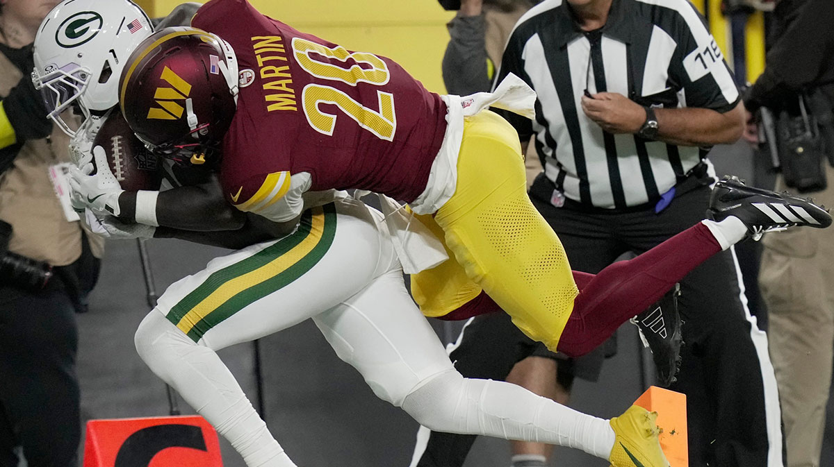 Green Bay Packers wide receiver Jayden Reed (11) is injured while being tackled by Washington Commanders safety Quan Martin (20) during the first quarter at Lambeau Field.