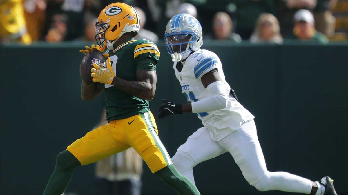 Green Bay Packers wide receiver Matthew Golden (0) catches a pass in front of Detroit Lions cornerback Amik Robertson (21) on Sunday, September 7, 2025, at Lambeau Field
