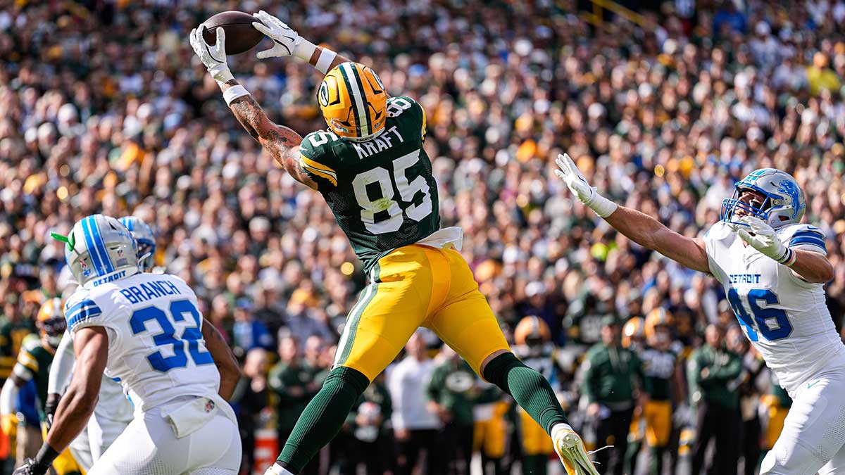 Green Bay Packers tight end Tucker Kraft (85) makes a catch for a touchdown against Detroit Lions safety Brian Branch (32) during the first half at Lambeau Field in Green Bay, Wis., on Sunday, September 7, 2025.