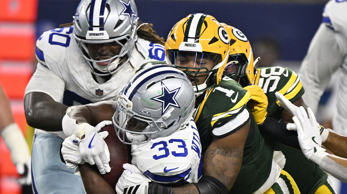 Green Bay Packers defensive end Micah Parsons (1) tackles Dallas Cowboys running back Javonte Williams (33) in the third quarter at AT&T Stadium.