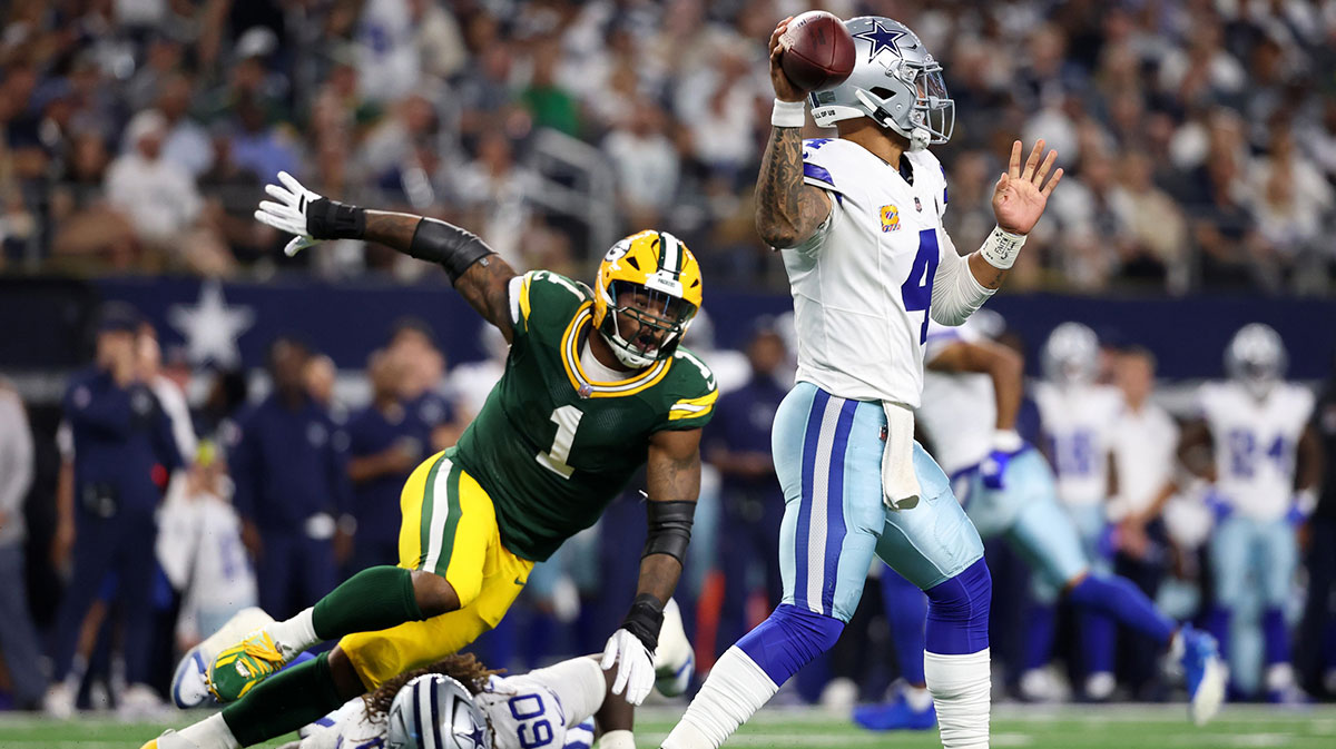 Dallas Cowboys quarterback Dak Prescott (4) throws under pressure from Green Bay Packers defensive end Micah Parsons (1) in the first quarter at AT&T Stadium.