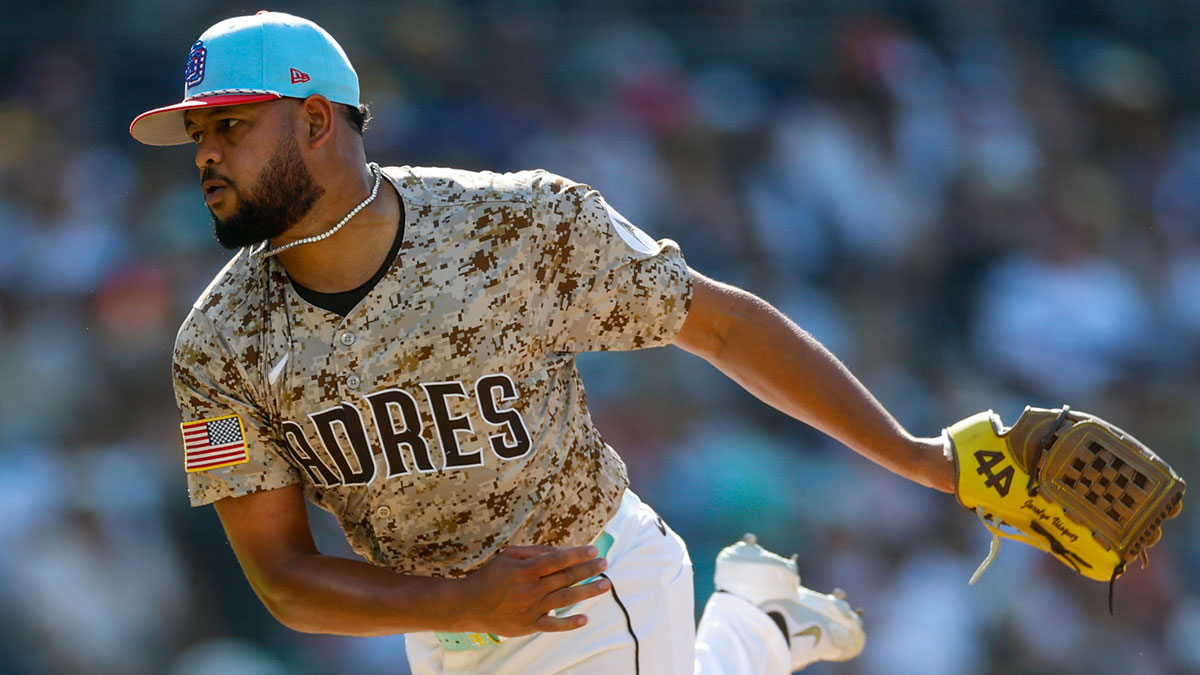 Padres starting pitcher Randy Vasquez (98) throws a pitch during the fifth inning against the Texas Rangers at Petco Park with Rockies logo in the background