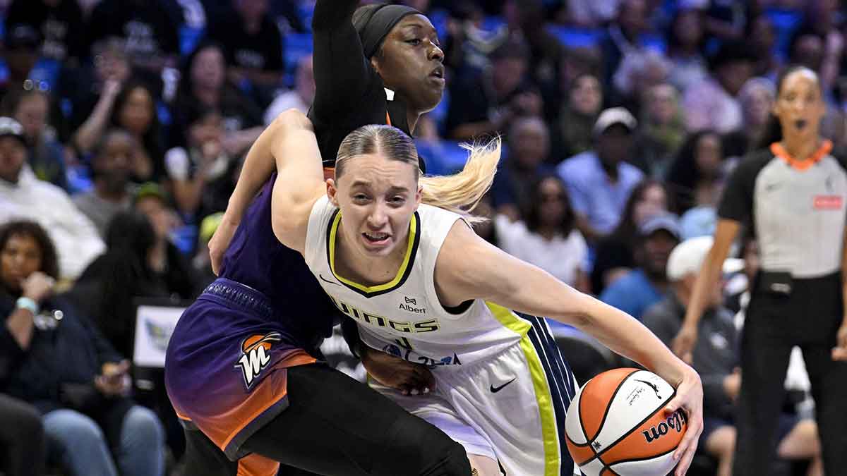 Dallas Wings guard Paige Bueckers (5) is fouled by Phoenix Mercury guard Kahleah Copper (2) during the first half at College Park Center.