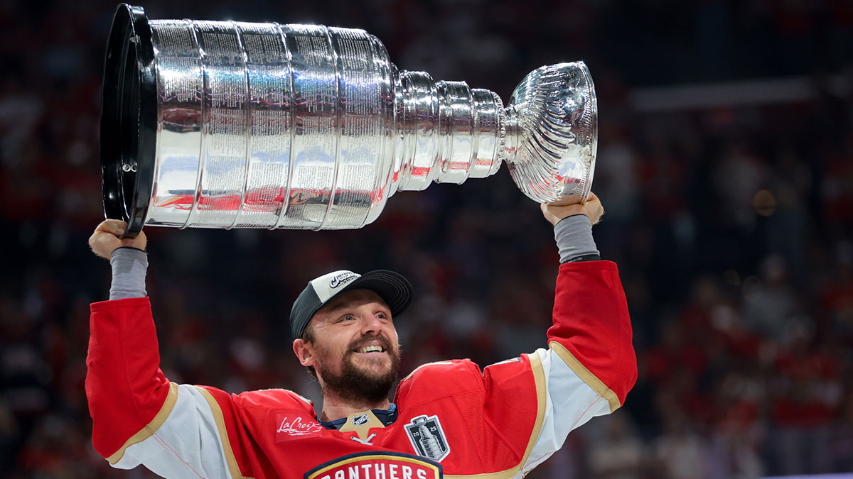 Florida Panthers center Sam Reinhart (13) hoists the Stanley Cup after winning game six of the 2025 Stanley Cup Final against the Edmonton Oilers at Amerant Bank Arena.