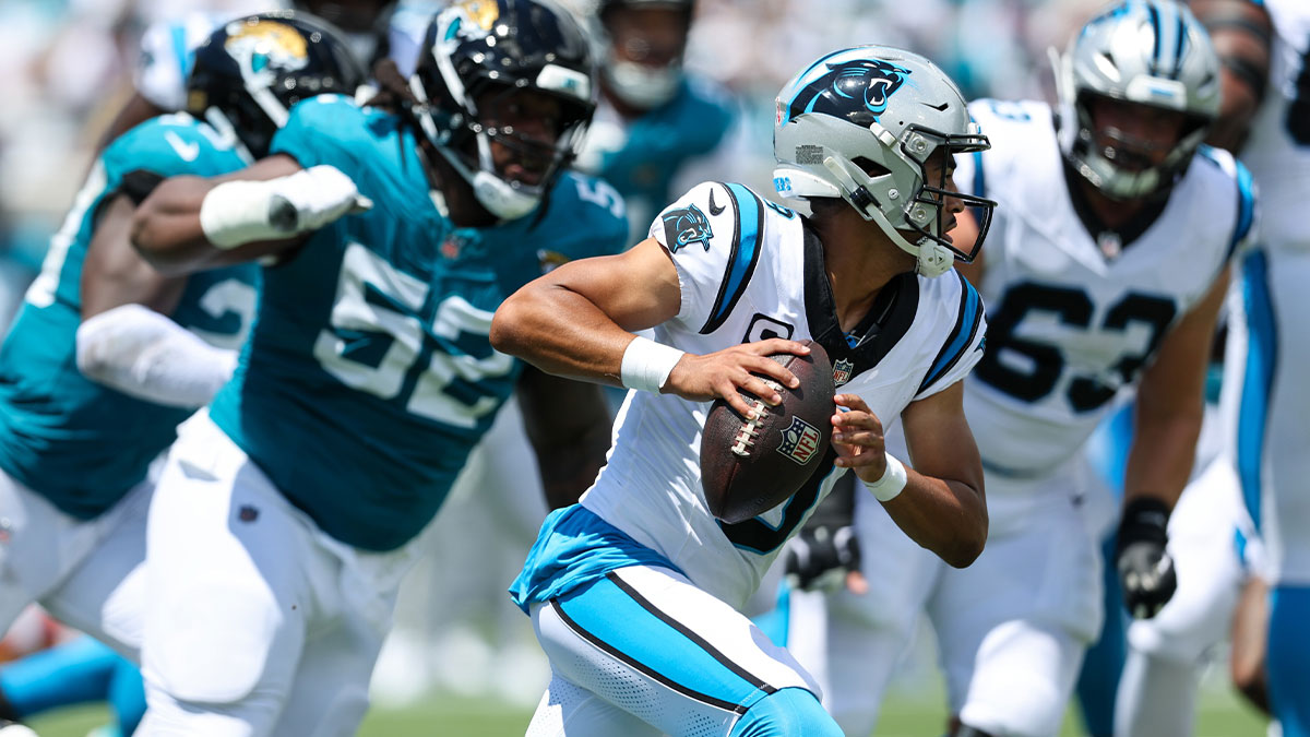 Carolina Panthers quarterback Bryce Young (9) rolls out against the pressure by the Carolina Panthers defense during the first half at EverBank Stadium.