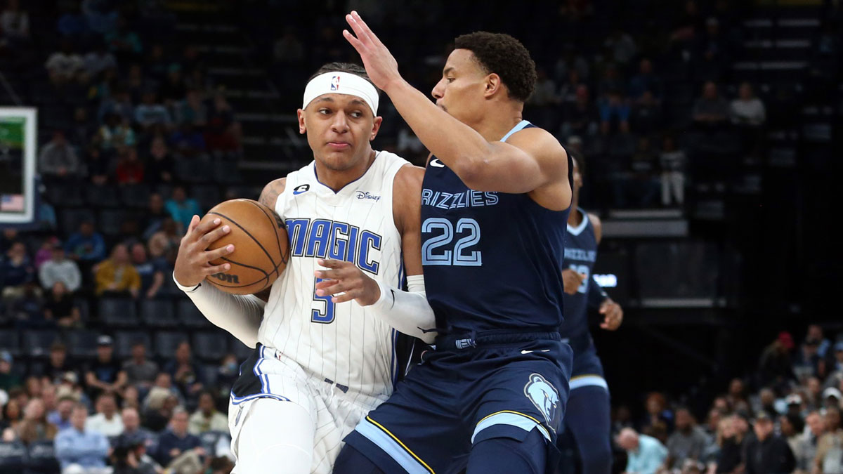Orlando Magic forward Paolo Banchero (5) drives to the basket as Memphis Grizzlies guard Desmond Bane (22) defends during the first half at FedExForum.
