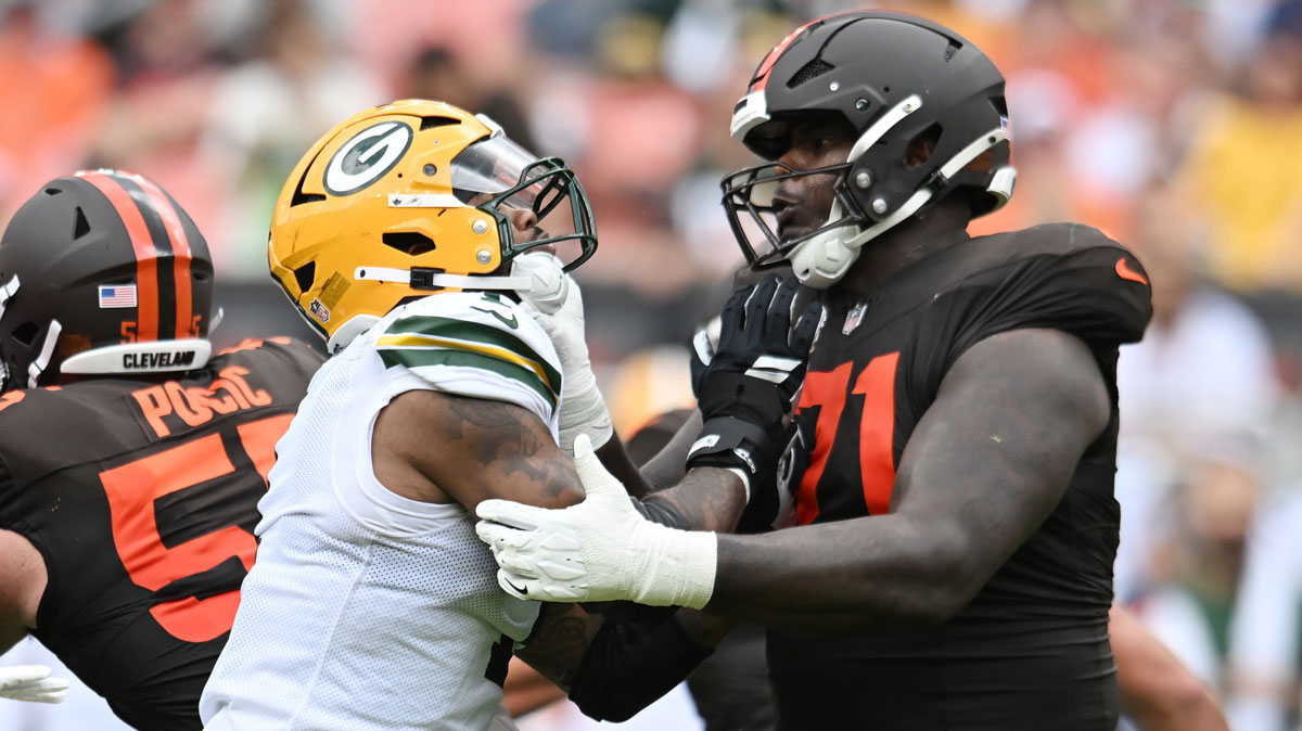 Cleveland Browns offensive tackle Cornelius Lucas (71) blocks Green Bay Packers defensive end Micah Parsons (1) during the second half at Huntington Bank Field.