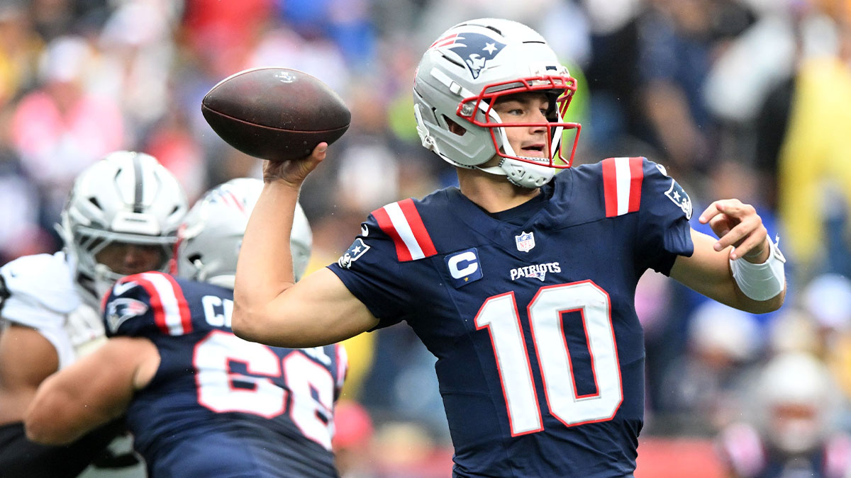 Patriots quarterback Drake Maye (10) drops back to pass against the Las Vegas Raiders in the first half at Gillette Stadium with Josh Allen and Bill Simmons in the background