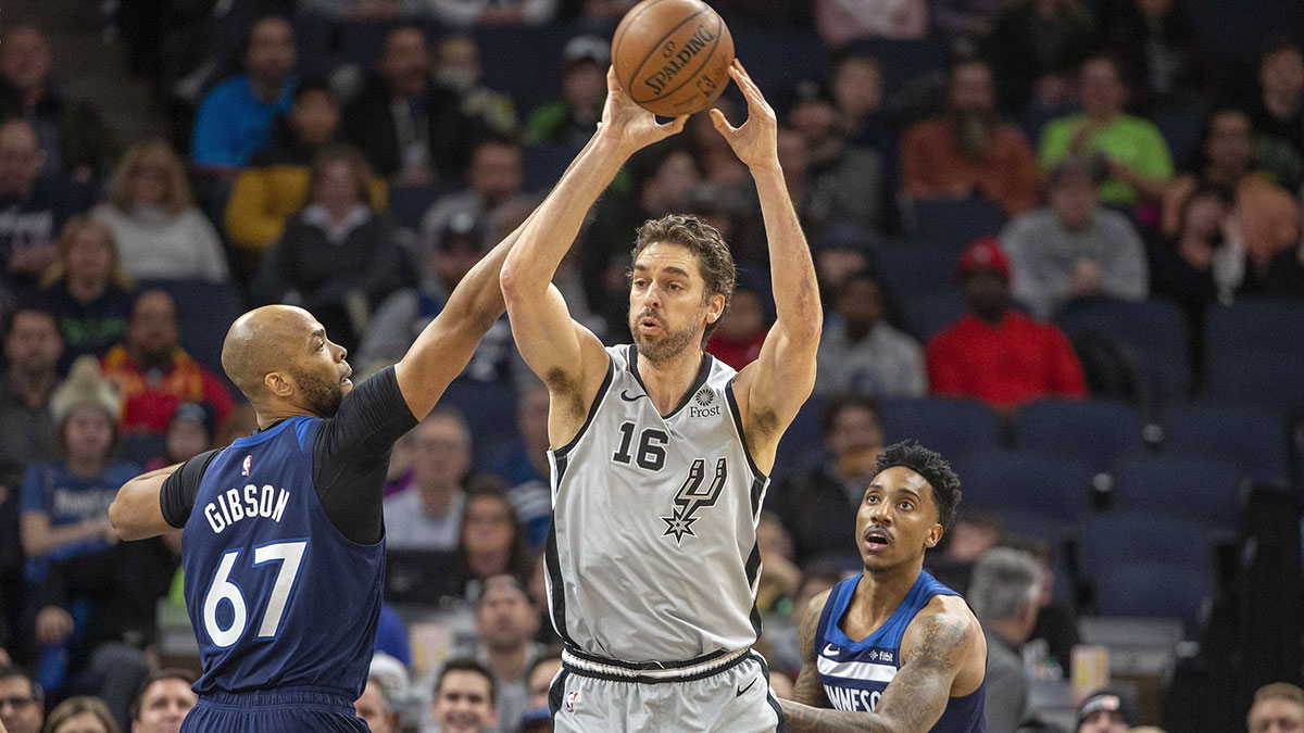 San Antonio Spurs center Pau Gasol (16) looks to pass the ball as Minnesota Timberwolves forward Taj Gibson (67) and guard Jeff Teague (0) play defense in the first half at Target Center.