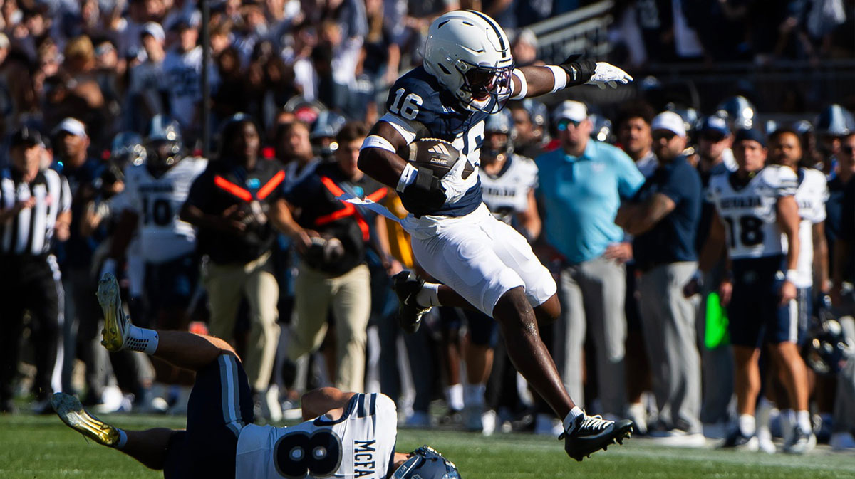 Penn State King Mack (16) leaps over a defender as he returns a kick in the first half of an NCAA football game against Nevada, Saturday, August 30, 2025, in State College, Pa.