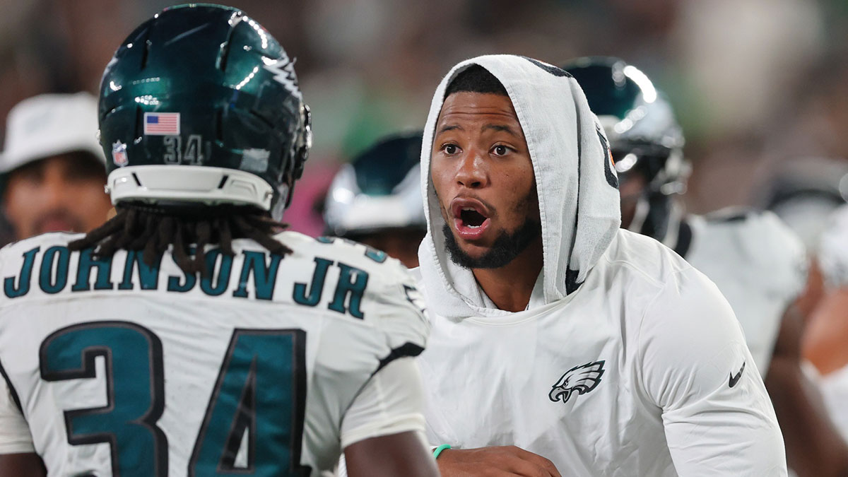 Philadelphia Eagles running back Montrell Johnson Jr. (34) is greeted by running back Saquon Barkley (26) after scoring a rushing touchdown during the second half against the New York Jets at MetLife Stadium.