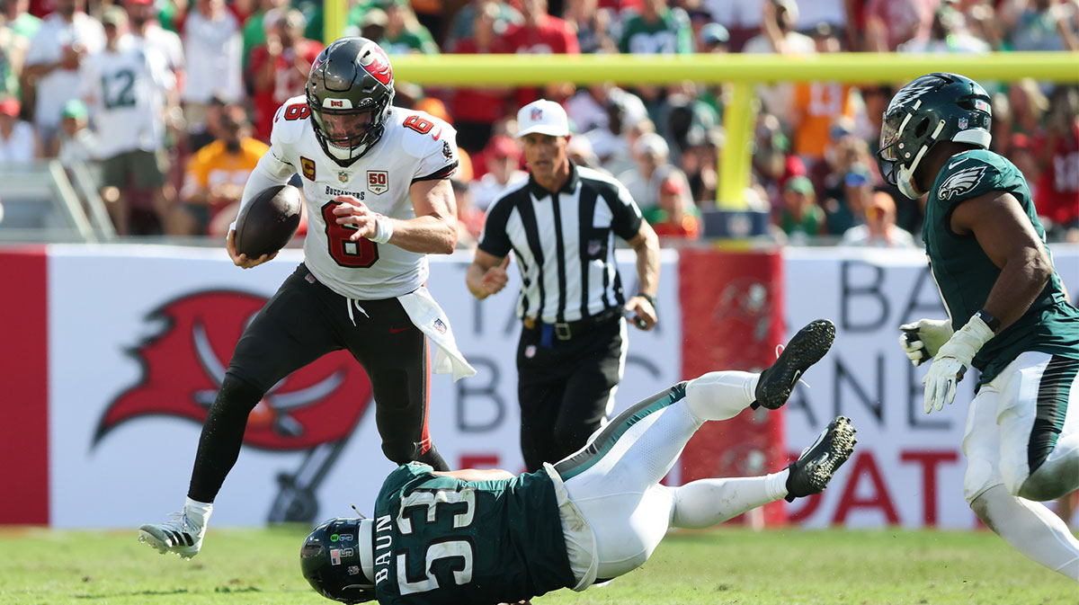 Tampa Bay Buccaneers quarterback Baker Mayfield (6) runs the ball while evading a tackle by Philadelphia Eagles linebacker Zack Baun (53) during the second half at Raymond James Stadium.