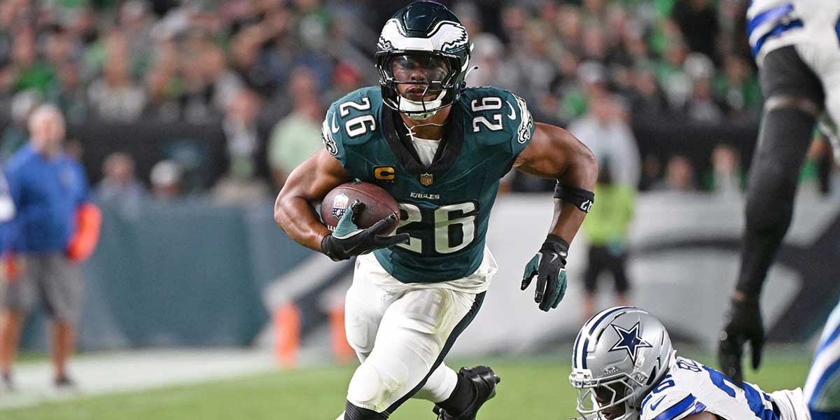 Philadelphia Eagles running back Saquon Barkley (26) runs past Dallas Cowboys cornerback DaRon Bland (26) at Lincoln Financial Field.