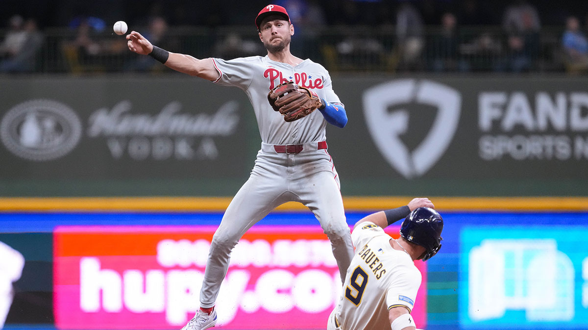 Philadelphia Phillies shortstop Trea Turner (7) turns a double play as Milwaukee Brewers first baseman Jake Bauers (9) slides into second base during the sixth inning at American Family Field.