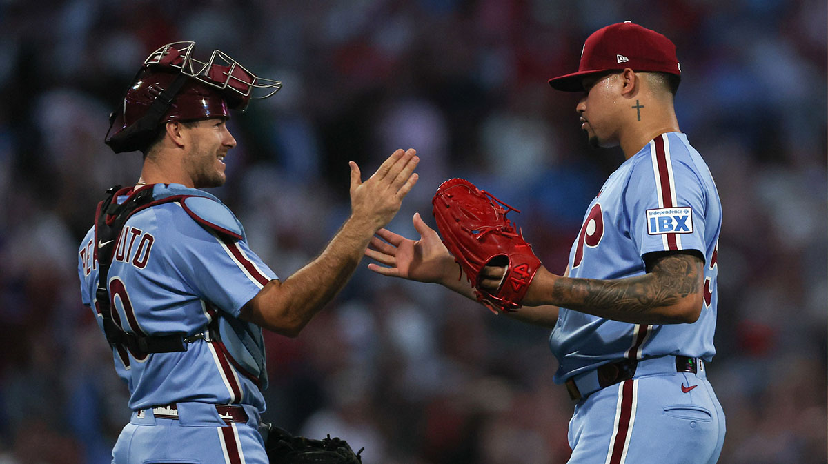 Philadelphia Phillies pitcher Jhoan Duran (59) and catcher J.T. Realmuto (10) shake hands after a win against the New York Mets at Citizens Bank Park. Mandatory Credit: Bill Streicher-Imagn Images