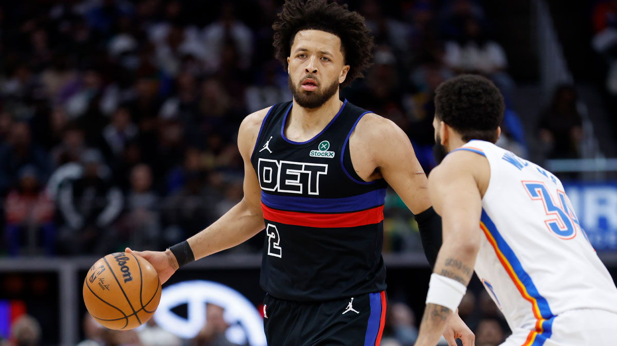 Detroit Pistons guard Cade Cunningham (2) dribbles defended by Oklahoma City Thunder forward Kenrich Williams (34) in the first half at Little Caesars Arena.
