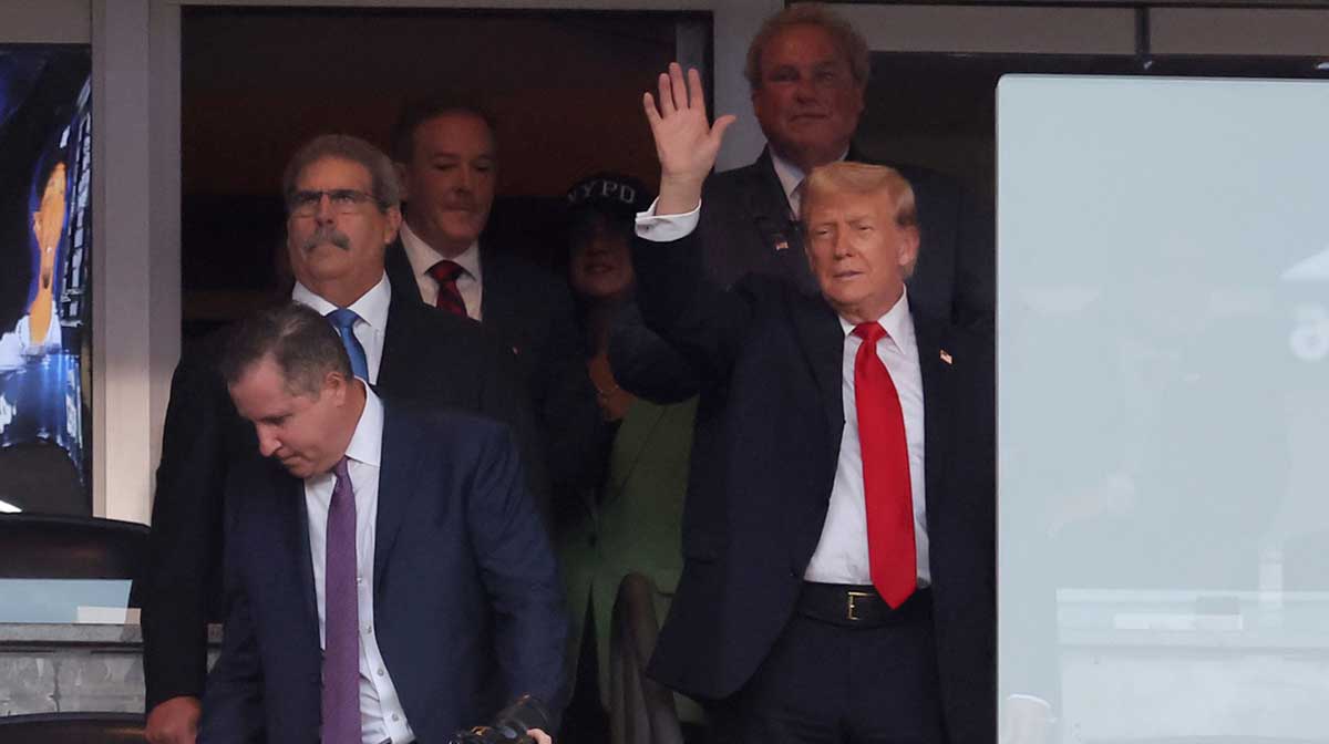 President of the United States Donald Trump waves as he enters his box before a game between the Detroit Tigers and the New York Yankees at Yankee Stadium.