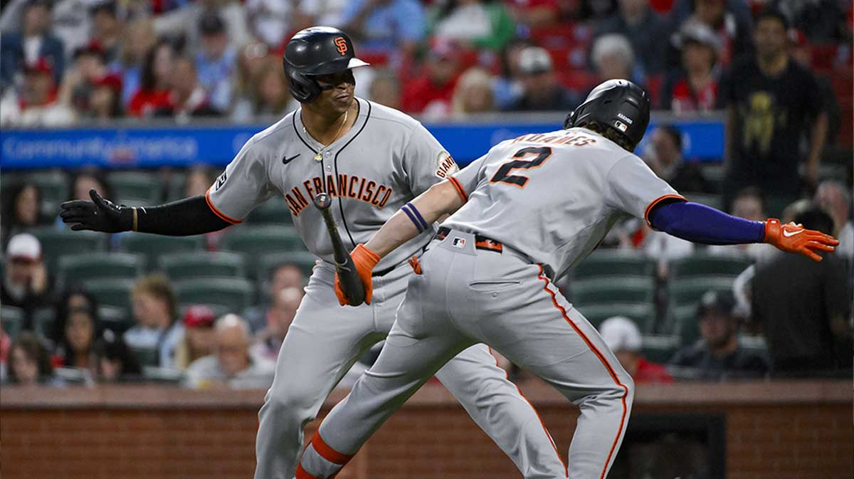 San Francisco Giants designated hitter Rafael Devers (16) celebrates with shortstop Willy Adames (2) after hitting a solo home run against the St. Louis Cardinals during the first inning at Busch Stadium.