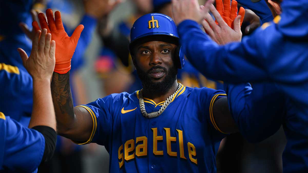 Seattle Mariners left fielder Randy Arozarena (56) celebrates in the dugout after scoring a run against the Los Angeles Angels during the second inning at T-Mobile Park. 