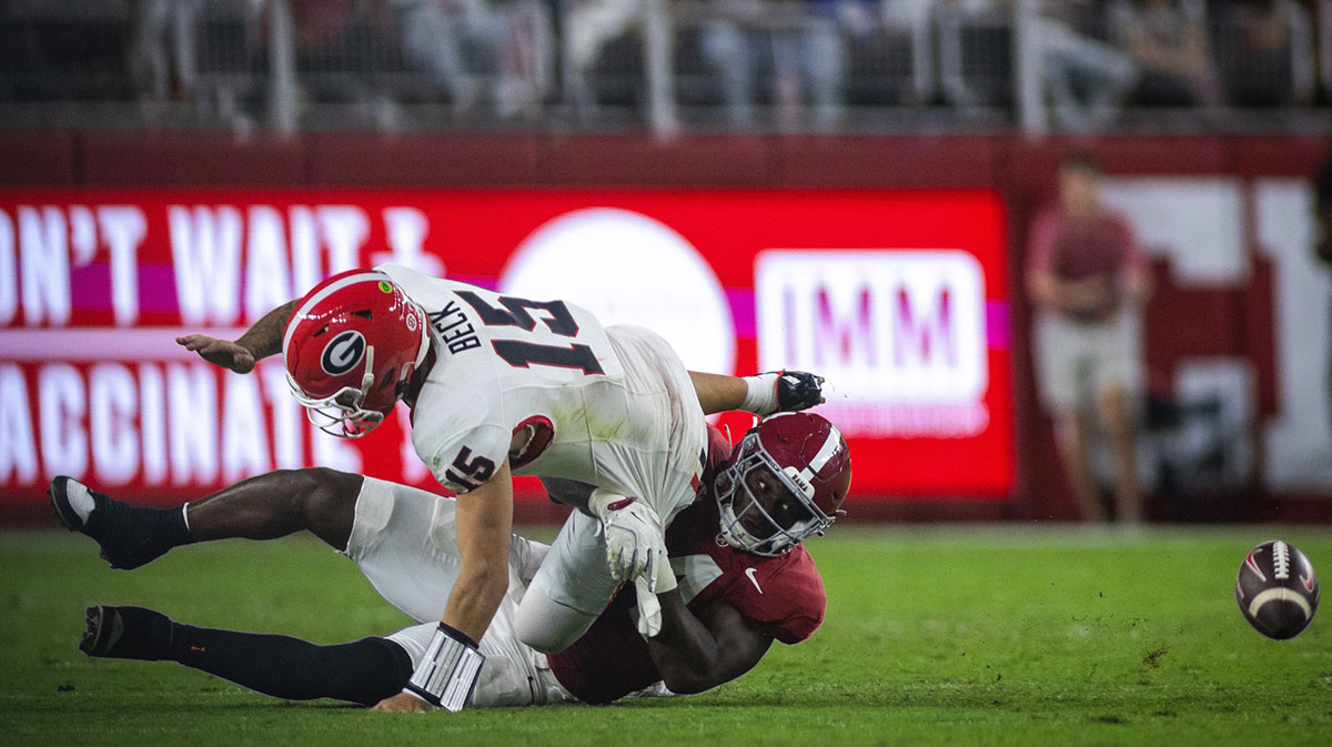 Alabama Crimson Tide linebacker Qua Russaw (4) causes a fumble by Georgia Bulldogs quarterback Carson Beck (15) during the third quarter at Bryant-Denny Stadium.