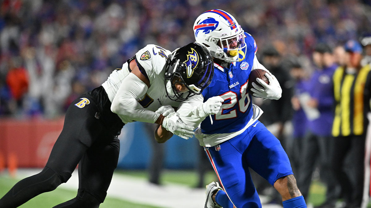 Buffalo Bills running back Ty Johnson (26) is pushed out of bounds by Baltimore Ravens safety Kyle Hamilton (14) in the first quarter at Highmark Stadium.