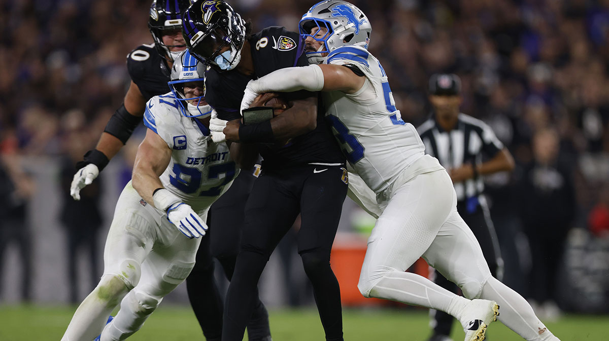 Detroit Lions linebacker Trevor Nowaske (53)and defensive end Aidan Hutchinson (97) tackles Baltimore Ravens quarterback Lamar Jackson (8) during the first half at M&T Bank Stadium.