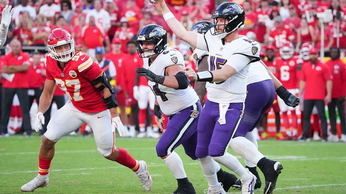 Baltimore Ravens quarterback Cooper Rush (15) throws a pass as Kansas City Chiefs defensive end Ashton Gillotte (97) defends during the fourth quarter at GEHA Field at Arrowhead Stadium.
