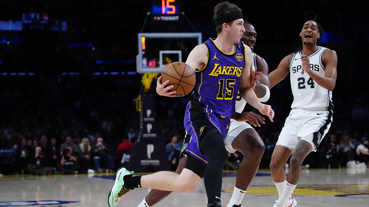 Los Angeles Lakers guard Austin Reaves (15) dribbles the ball against San Antonio Spurs center Bismack Biyombo (18) and guard Devin Vassell (24) in the first half at Crypto.com Arena