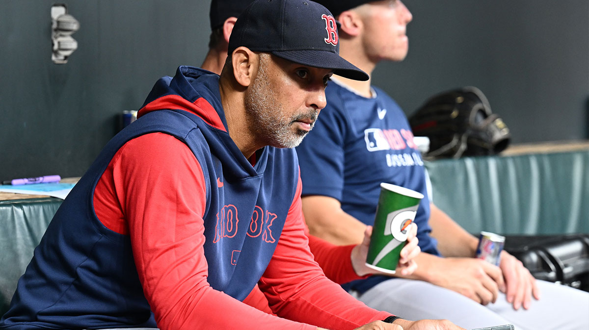 Red Sox manager Alex Cora (13) sits in the dugout before the game between the Baltimore Orioles and the Boston Red Sox at Oriole Park at Camden Yards with Red Sox catcher Ali Sanchez in the background