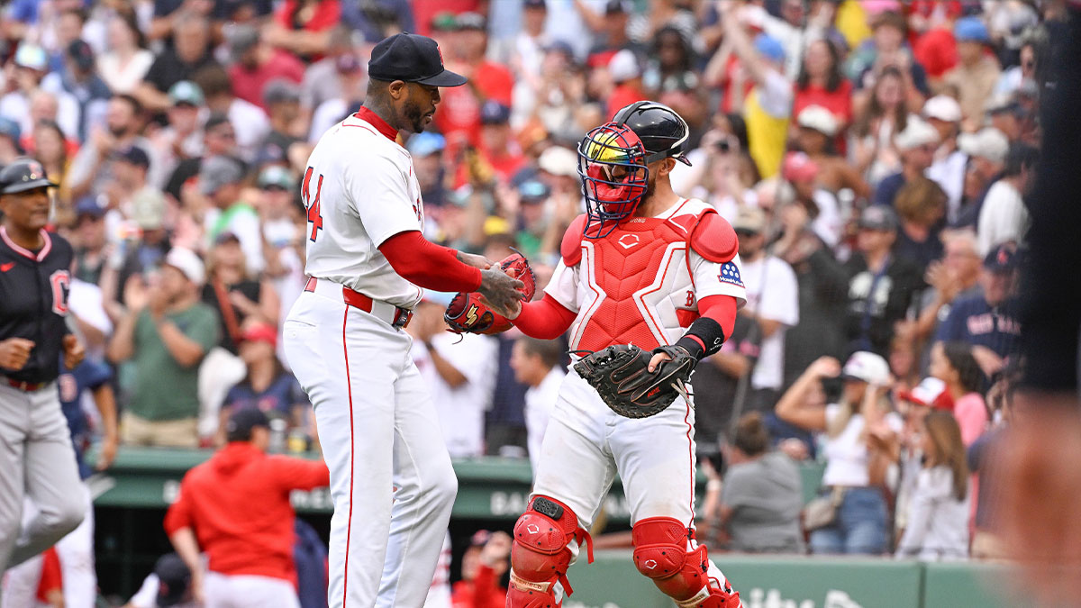 Boston Red Sox relief pitcher Aroldis Chapman (44) and catcher Connor Wong (12) celebrate beating the Cleveland Guardians at Fenway Park.
