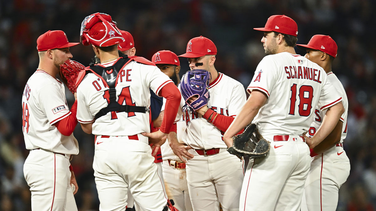 Los Angeles Angels pitcher Reid Detmers (48), shortstop Zach Neto (9), catcher Logan O'Hoppe (14), first baseman Nolan Schanuel (18), and other teammates meet at the mound against the San Francisco Giants during the sixth inning at Angel Stadium.