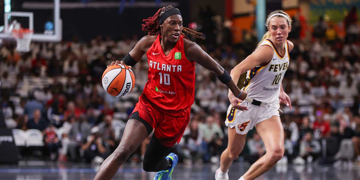 Atlanta Dream guard Rhyne Howard (10) dribbles past Indiana Fever guard Lexie Hull (10) in the first quarter during game one of round one for the 2025 WNBA Playoffs at Gateway Center Arena at College Park.