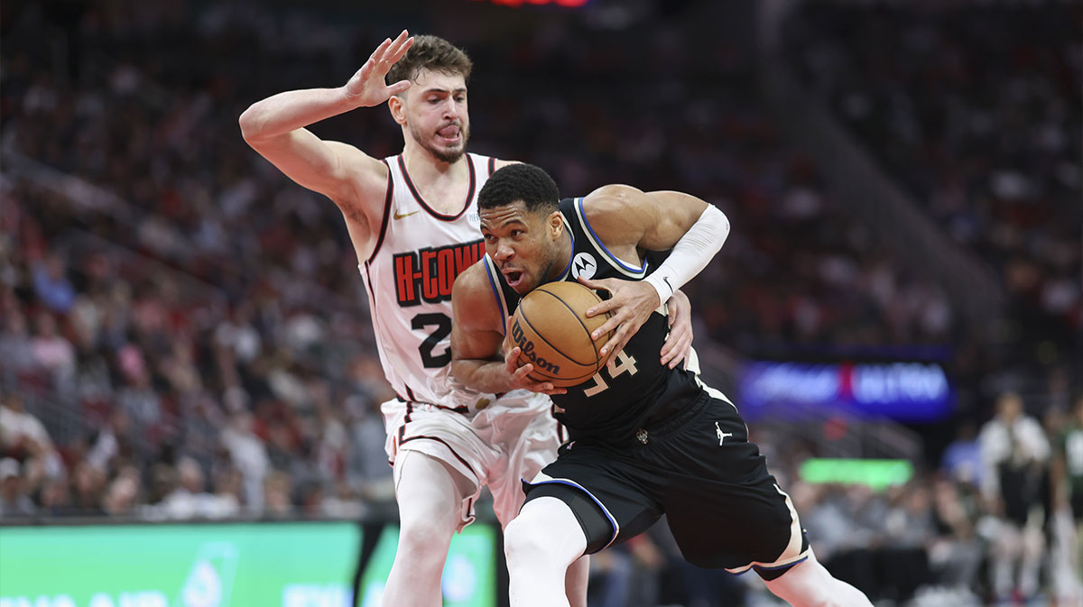 Bucks forward Giannis Antetokounmpo (34) drives with the ball as Houston Rockets center Alperen Sengun (28) defends during the fourth quarter at Toyota Center with the Turkey logo in the background
