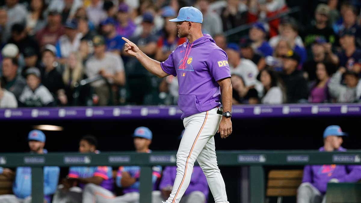 Colorado Rockies interim manager Warren Schaeffer (34) gestures for a pitching change in the fifth inning against the Chicago Cubs at Coors Field.