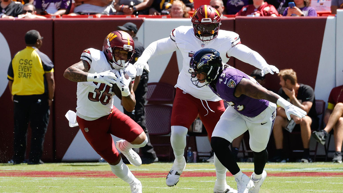 Baltimore Ravens outside linebacker Mike Green (45) prepares to tackle the Washington Commanders running back Chris Rodriguez Jr. (36) in the first quarter at Northwest Stadium. Mandatory Credit: Jordyn Harris-Imagn Images at Northwest Stadium.