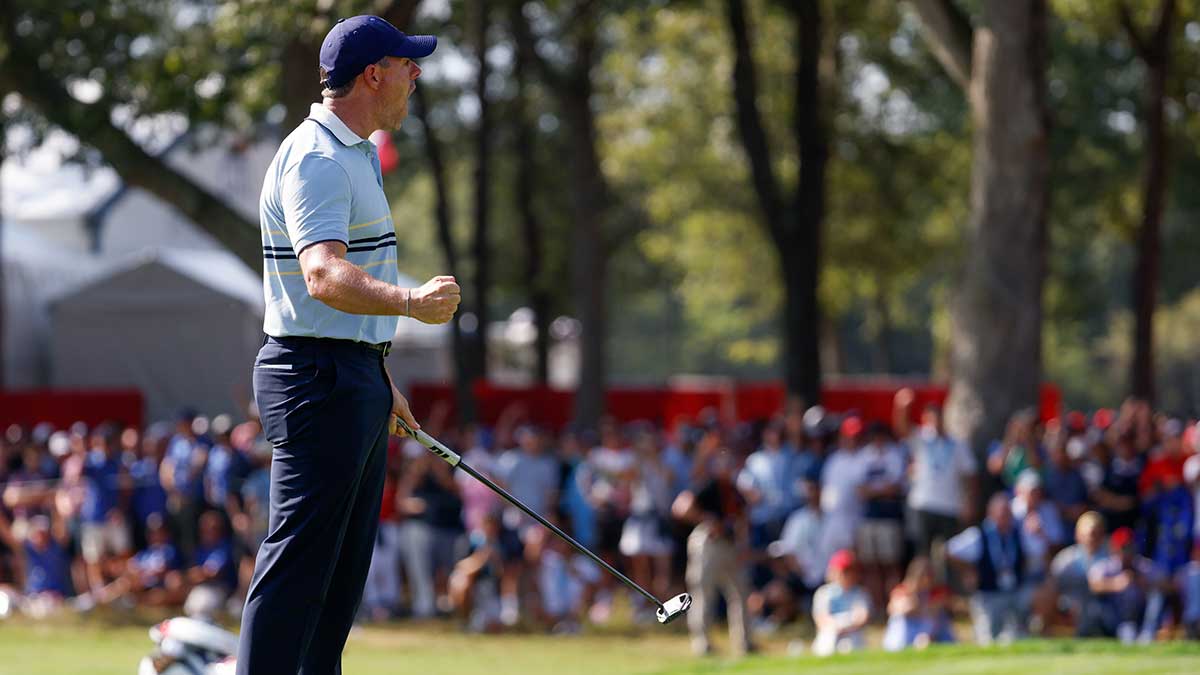 Team Europe golfer Rory McIlroy celebrates after his putt on the seventh green with Shane Lowry on the first day of competition for the Ryder Cup at Bethpage Black.